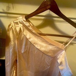 Cream silk blouse slides off the shoulder with tiny strap